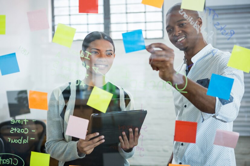 business-colleagues-discussing-sticky-notes-glass_107420-81637